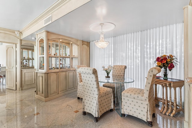 dining area featuring crown molding and an inviting chandelier