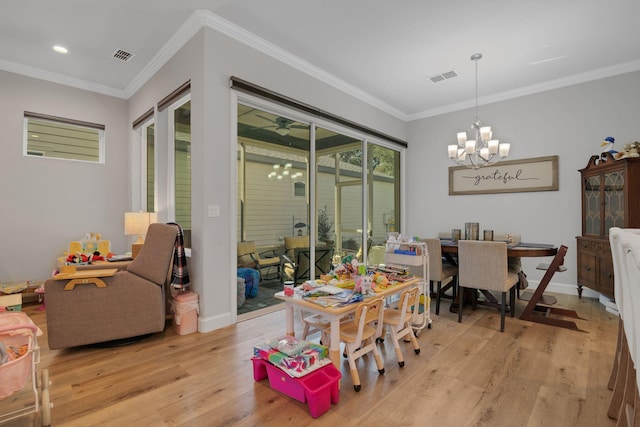 6450 SW 77th St, Gainesville, FL 32608 - dining space with ornamental molding, light hardwood / wood-style floors, and a notable chandelier