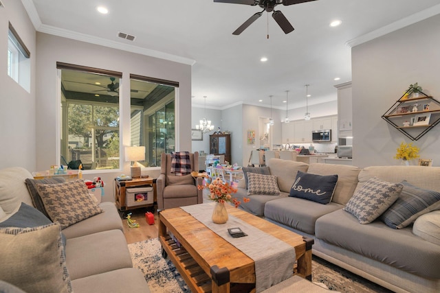 6450 SW 77th St, Gainesville, FL 32608 - living room featuring hardwood / wood-style flooring, crown molding, and ceiling fan with notable chandelier