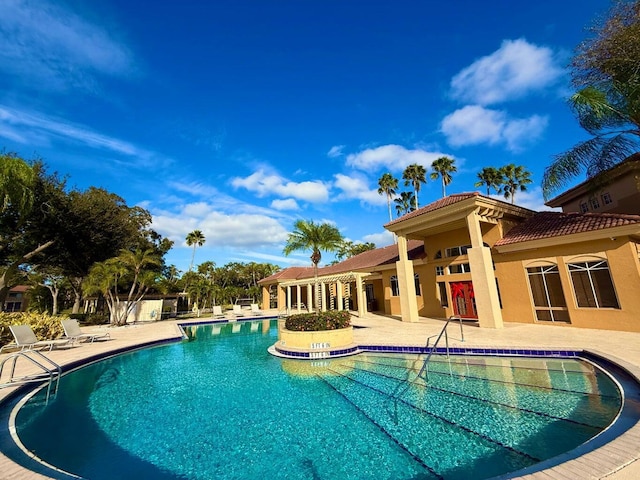 view of swimming pool featuring a patio area