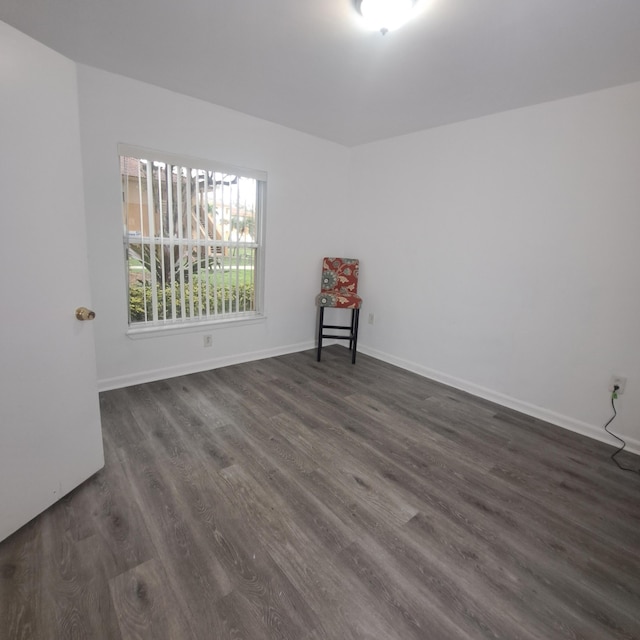 spare room with dark wood-type flooring