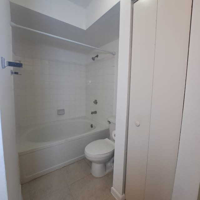 bathroom with tile patterned floors, toilet, and bathing tub / shower combination