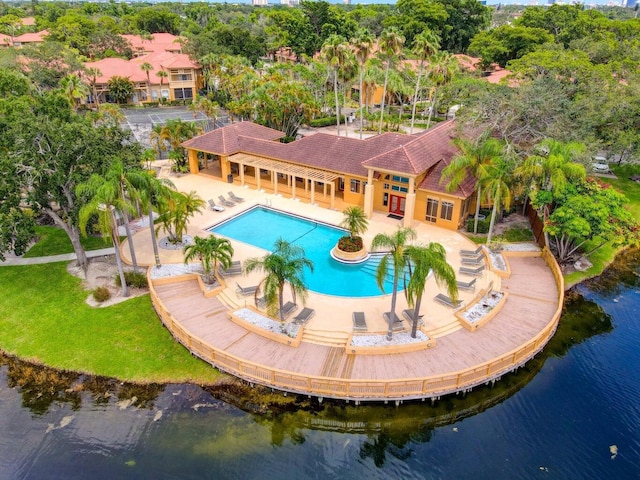 view of pool featuring a patio and a water view