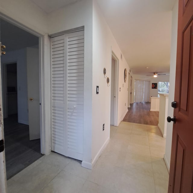 hall featuring light tile patterned floors