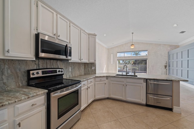 kitchen with white cabinetry, sink, decorative light fixtures, and appliances with stainless steel finishes