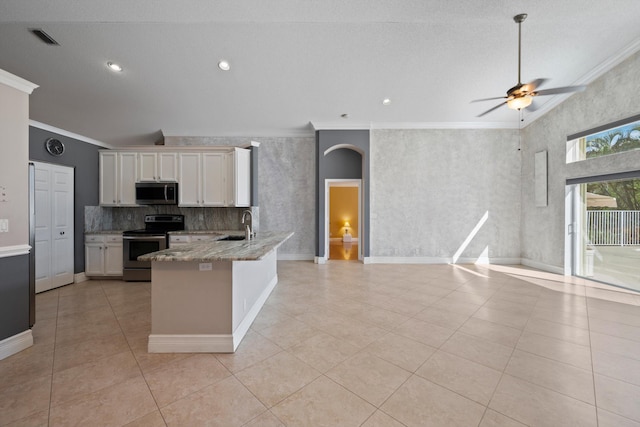 kitchen featuring crown molding, light tile patterned floors, appliances with stainless steel finishes, light stone countertops, and white cabinets