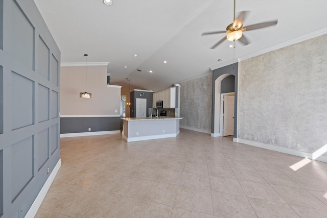 unfurnished living room featuring crown molding, lofted ceiling, light tile patterned floors, and ceiling fan