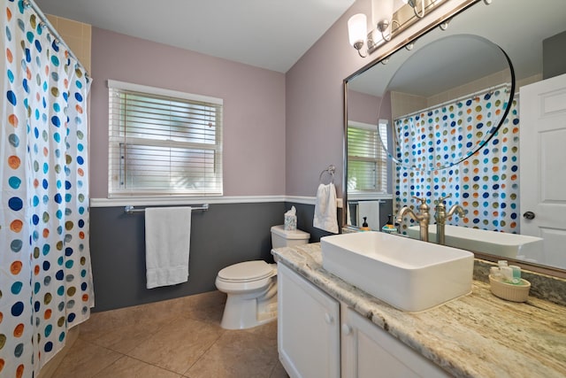 bathroom featuring a shower with curtain, tile patterned floors, toilet, and vanity