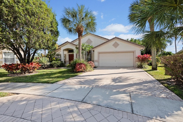 view of front of house with a garage and a front lawn