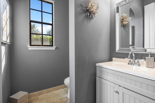 bathroom with vanity, toilet, and tile patterned flooring