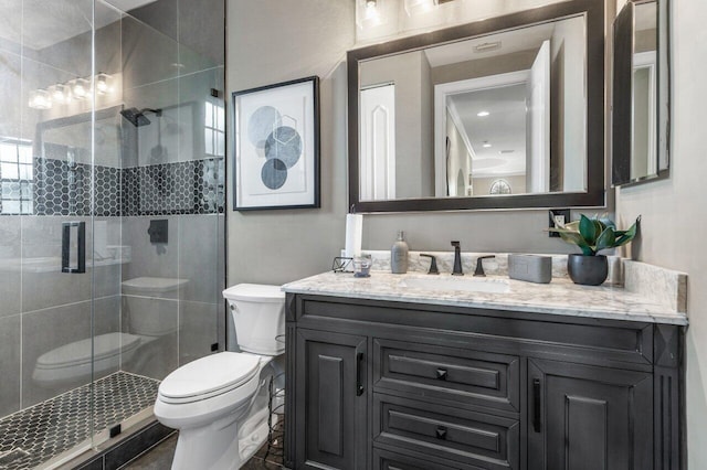 bathroom with vanity, toilet, and a shower with shower door