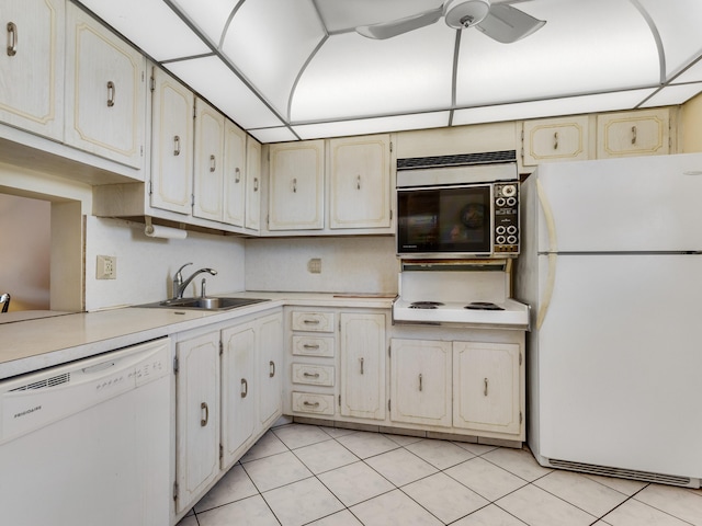 kitchen featuring ceiling fan, sink, light tile patterned floors, and white appliances