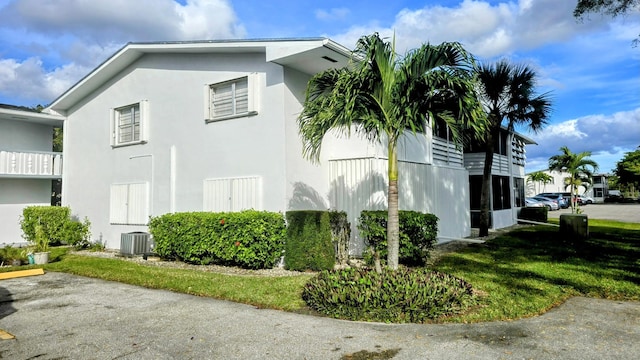 view of home's exterior featuring a yard and central air condition unit