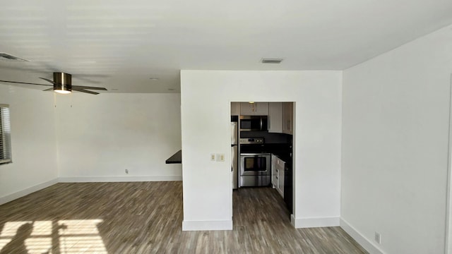 interior space with ceiling fan and wood-type flooring