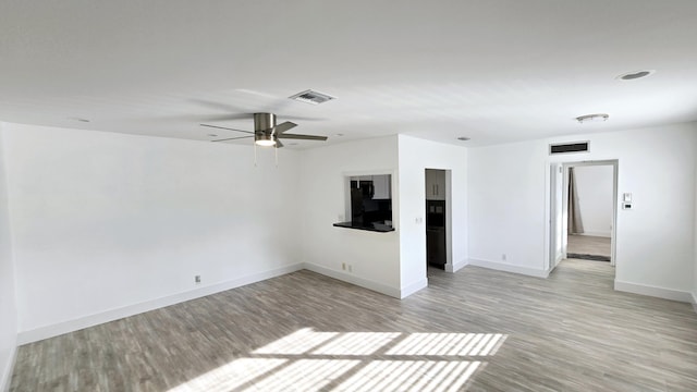 unfurnished room featuring ceiling fan and light hardwood / wood-style floors