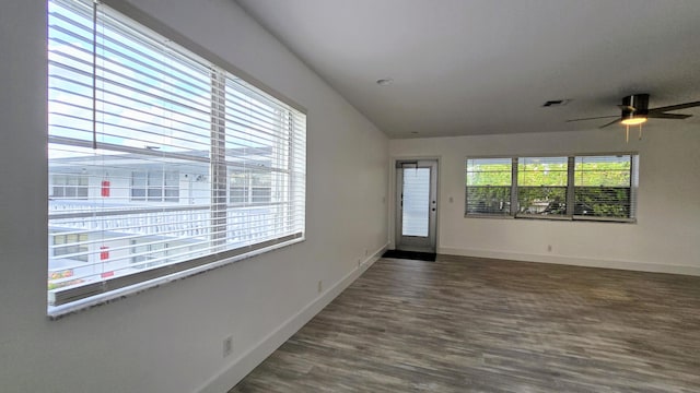 foyer featuring ceiling fan, a wealth of natural light, and dark hardwood / wood-style flooring