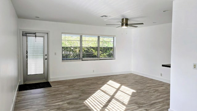 unfurnished room featuring ceiling fan and dark hardwood / wood-style floors