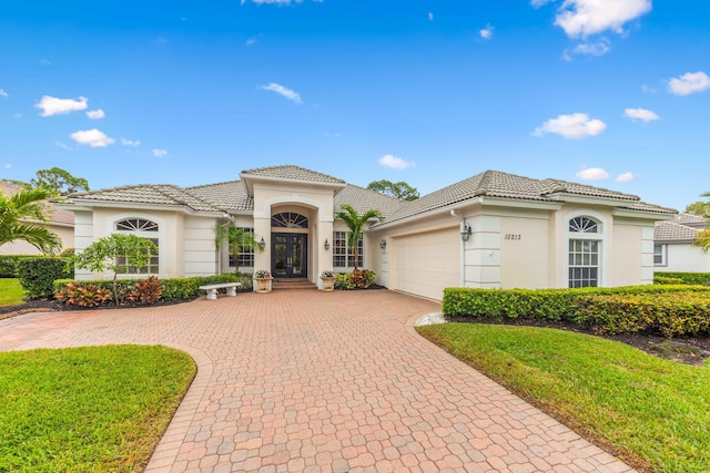 mediterranean / spanish house featuring a garage