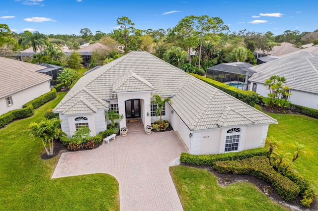 view of front of home with a garage and a front lawn