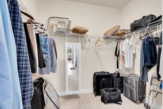 walk in closet with carpet