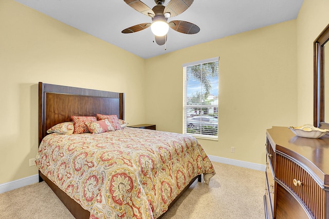 bedroom featuring light colored carpet and ceiling fan