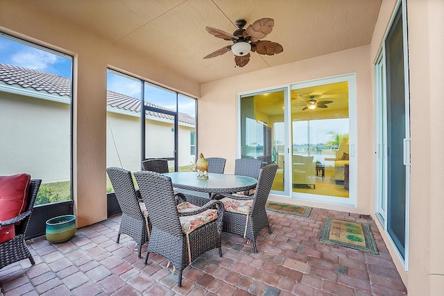 sunroom featuring a healthy amount of sunlight and ceiling fan