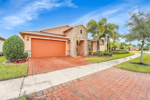 view of front of property with a garage and a front lawn