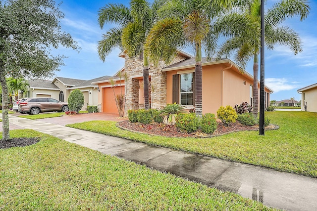 view of front of home with a garage and a front yard