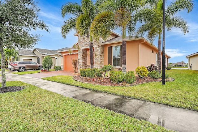 10211 SW Fernwood Ave, Port Saint Lucie, FL 34987 - view of front facade featuring stucco siding, concrete driveway, a front lawn, and a garage