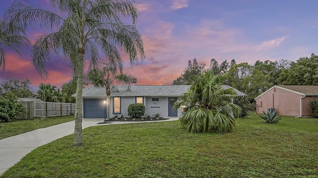 view of front of property with a yard and a garage