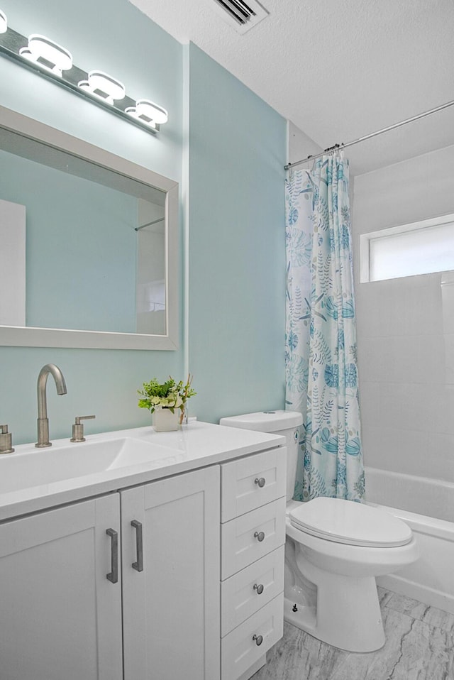 full bathroom featuring vanity, shower / bathtub combination with curtain, a textured ceiling, and toilet