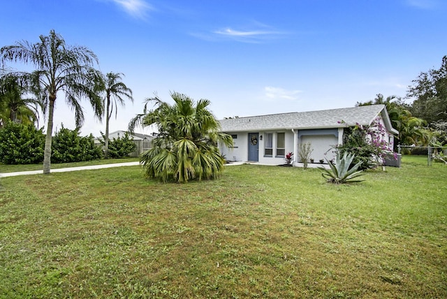 view of front of house with a garage and a front yard