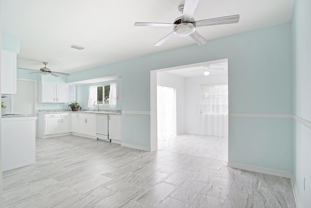 kitchen with white cabinetry, white dishwasher, and sink