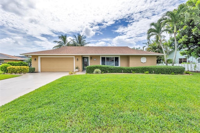 single story home featuring a garage and a front lawn