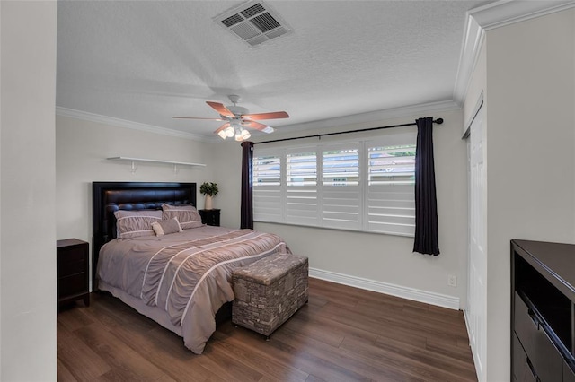 bedroom with ceiling fan, ornamental molding, dark hardwood / wood-style floors, and a textured ceiling