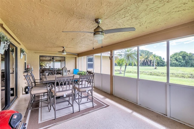 sunroom featuring ceiling fan