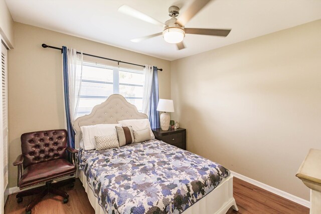 bedroom with a closet, ceiling fan, and wood-type flooring