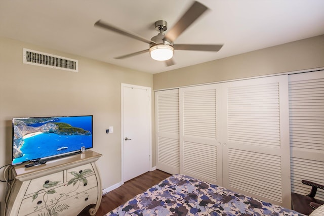 bedroom featuring ceiling fan, dark hardwood / wood-style flooring, and a closet