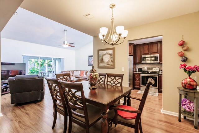 kitchen featuring light stone countertops, stainless steel appliances, light hardwood / wood-style floors, sink, and backsplash