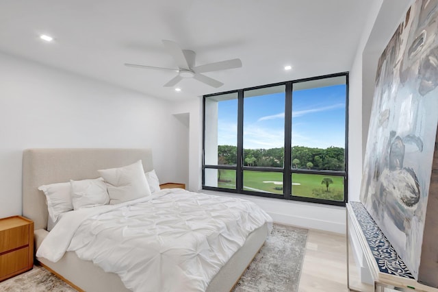 bedroom with ceiling fan and light wood-type flooring