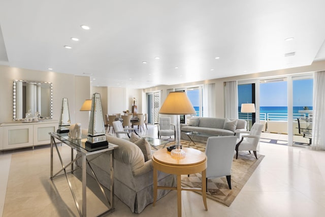 living room featuring a water view and light tile patterned flooring