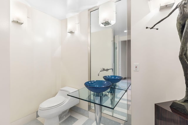 bathroom featuring sink and toilet