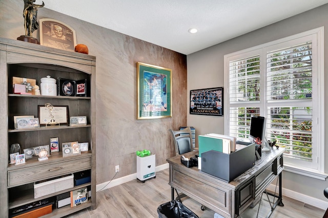 home office featuring a healthy amount of sunlight and light hardwood / wood-style flooring