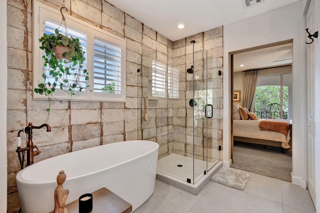 bathroom with tile patterned flooring, plenty of natural light, and plus walk in shower