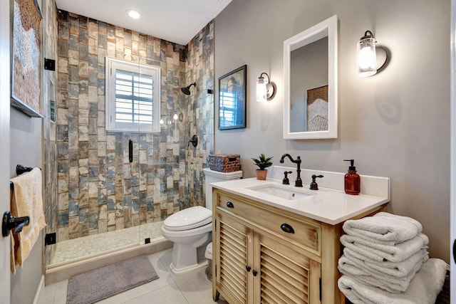 bathroom featuring walk in shower, vanity, toilet, and tile patterned flooring