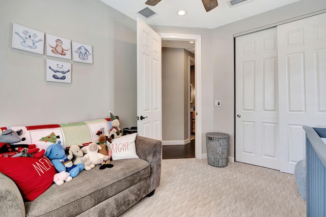 carpeted bedroom with ceiling fan and a closet