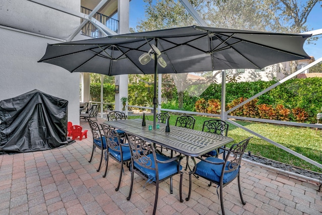 view of patio / terrace featuring glass enclosure