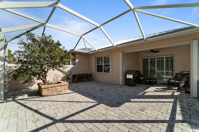 view of patio with ceiling fan and a lanai