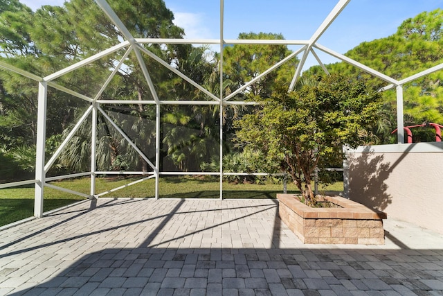 view of patio with glass enclosure
