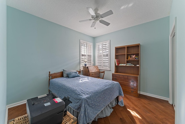 bedroom featuring hardwood / wood-style flooring, a textured ceiling, and ceiling fan